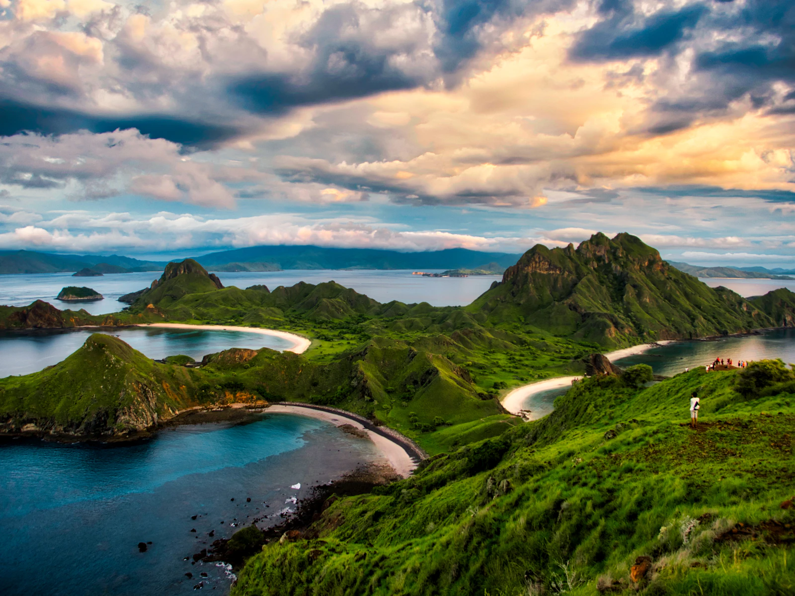 Landscape — green and brown mountains near body of water under white clouds and blue sky during daytime