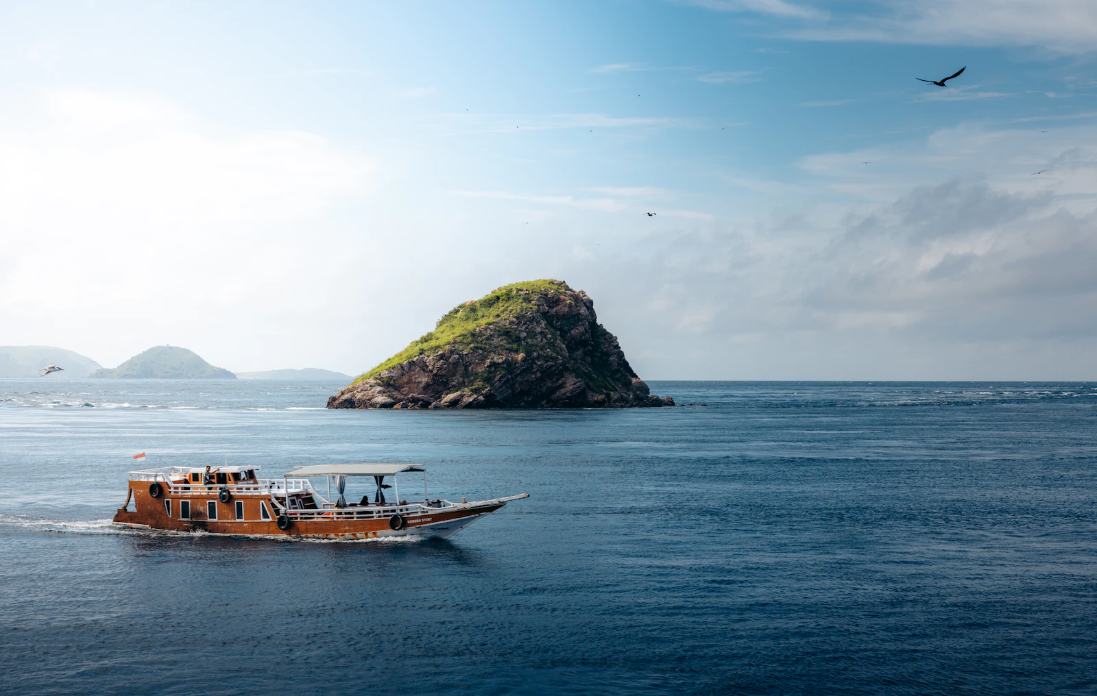 Harbor — A small boat in the middle of a large body of water
